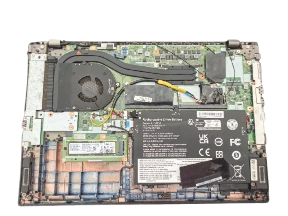 Laptop internals with concealed tracker module installed near the battery